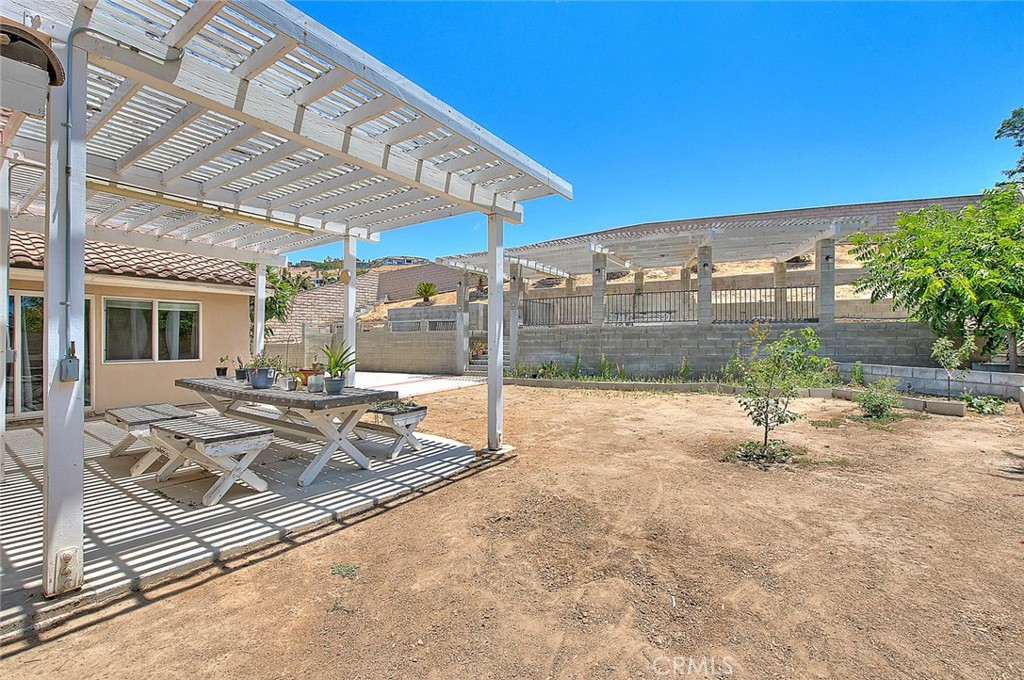 3340 May Court Riverside, CA 92503 - Photo 54 of 67 a view of a patio with a table and chairs under an umbrella