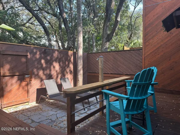 a view of backyard with a deck and wooden floor