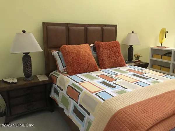 a bedroom with bed and window