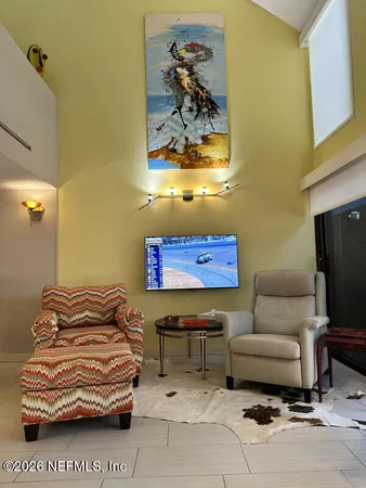 a living room with furniture and a mirror