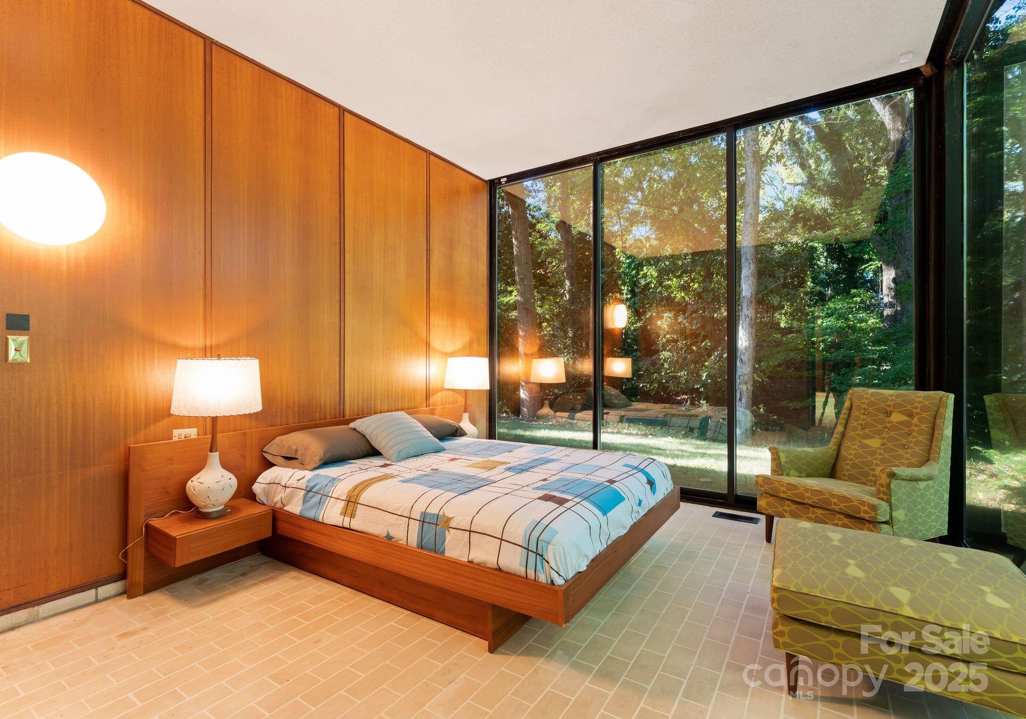 9331 Providence Road Charlotte, NC 28270 - Photo 25 of 40 a bedroom with bed couch and lamp next to a window