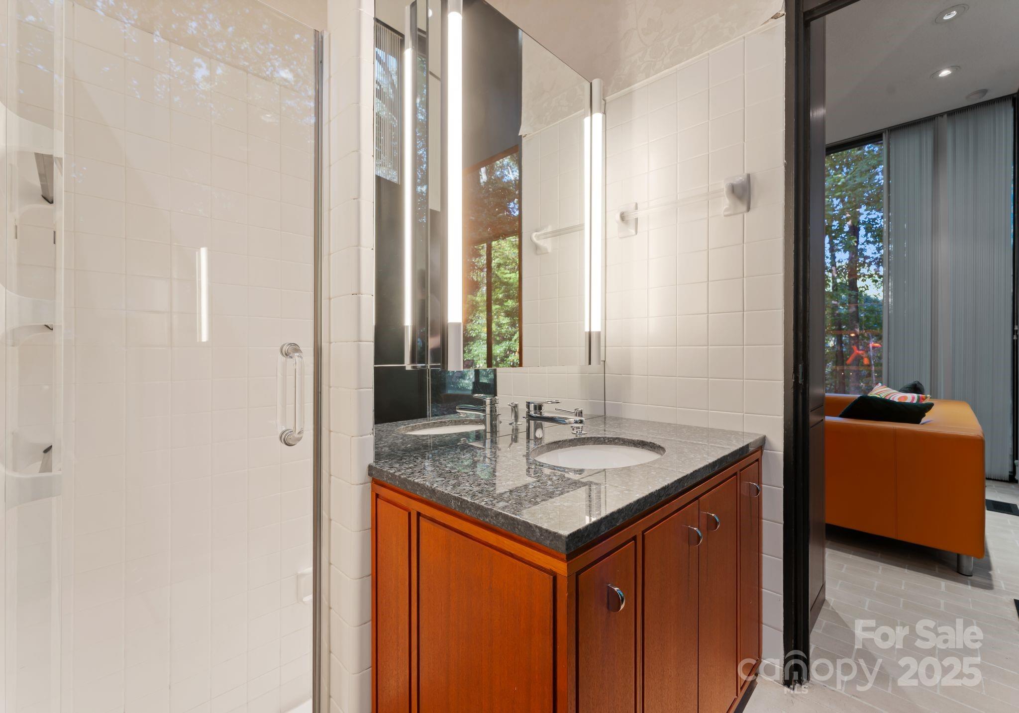9331 Providence Road Charlotte, NC 28270 - Photo 30 of 40 a bathroom with a granite countertop sink and a mirror