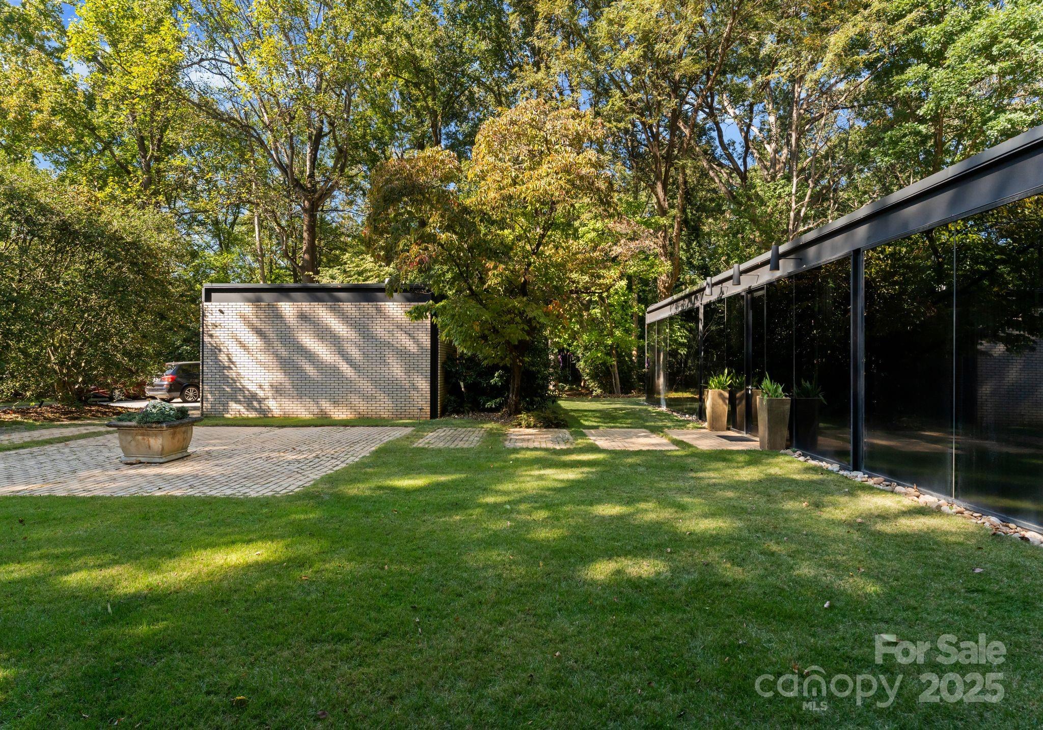9331 Providence Road Charlotte, NC 28270 - Photo 33 of 40 a view of a backyard with table and chairs and garden