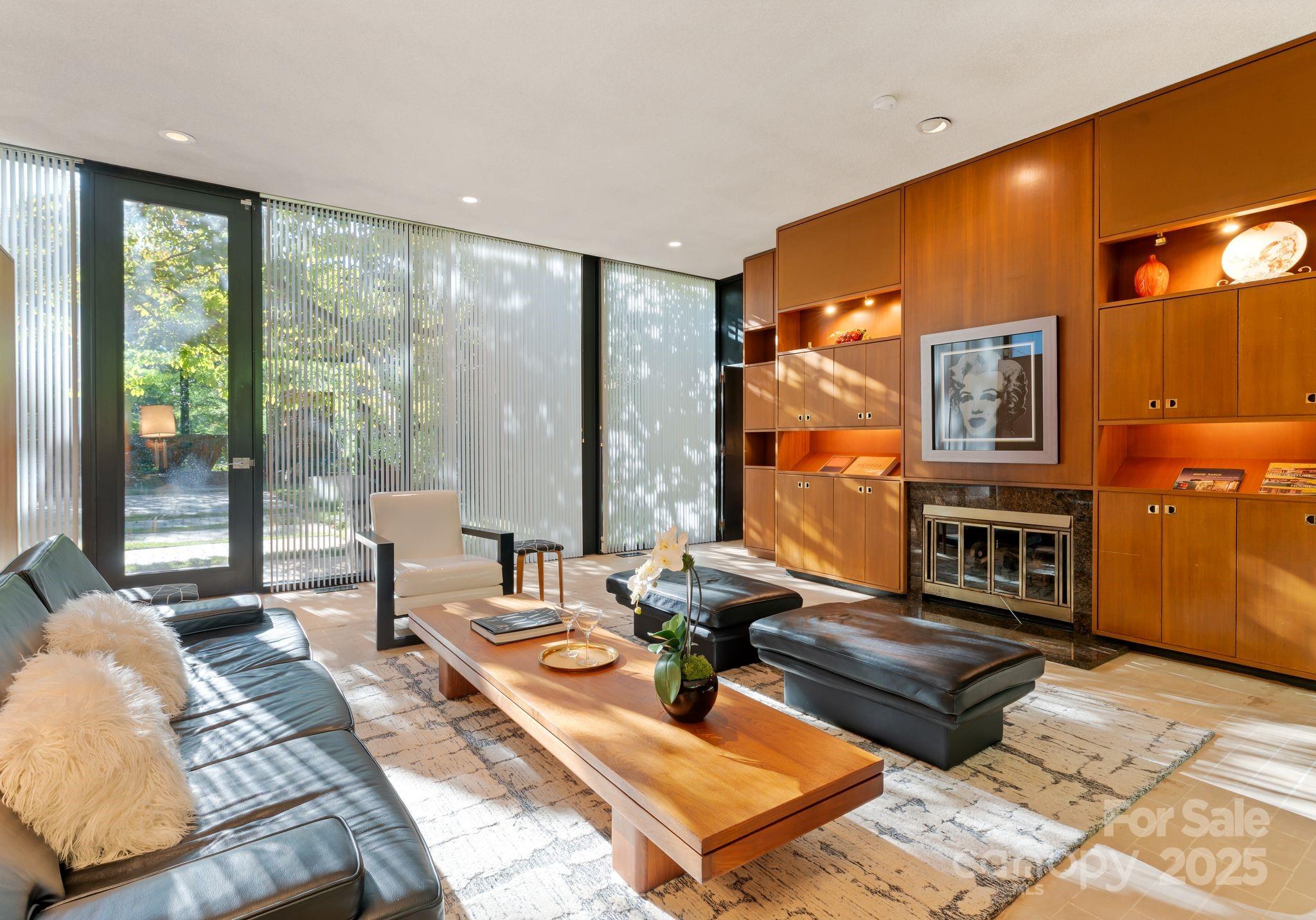9331 Providence Road Charlotte, NC 28270 - Photo 8 of 40 a living room with fireplace furniture and a floor to ceiling window