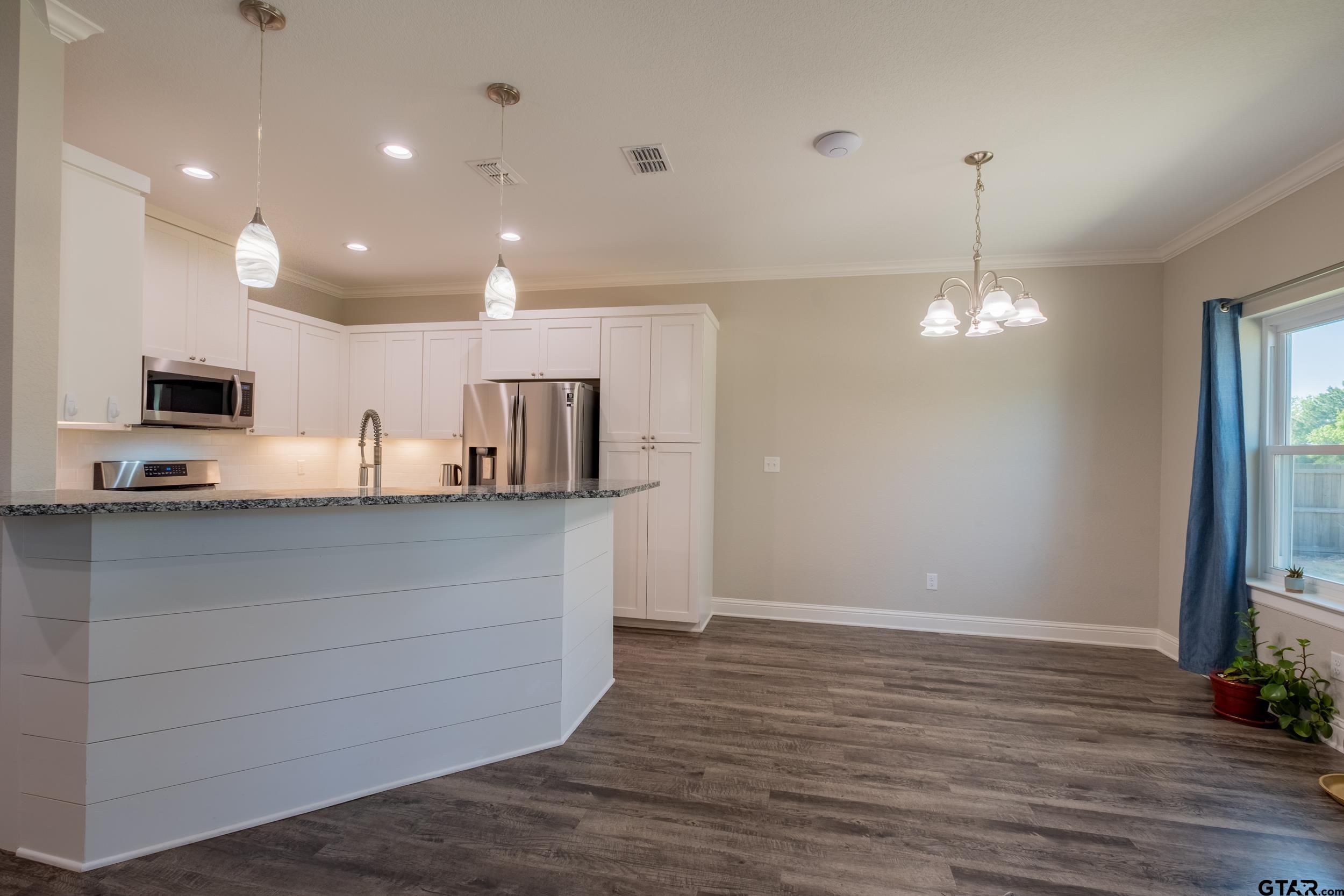 14348 County Road 452 Lindale, TX 75771 - Photo 11 of 45 a view of kitchen with granite countertop cabinets and refrigerator