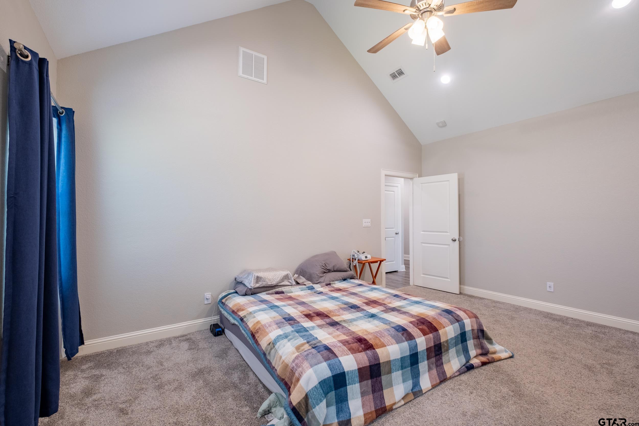 14348 County Road 452 Lindale, TX 75771 - Photo 12 of 45 a bedroom with a bed and a chandelier