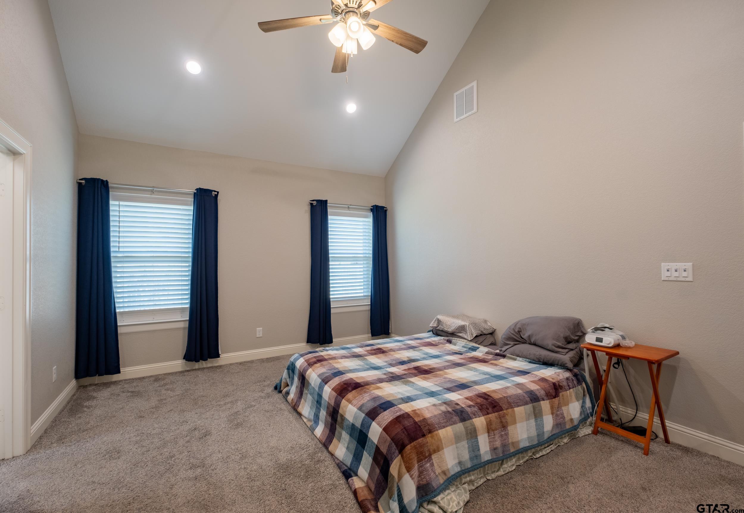 14348 County Road 452 Lindale, TX 75771 - Photo 13 of 45 a bedroom with a bed and a chandelier