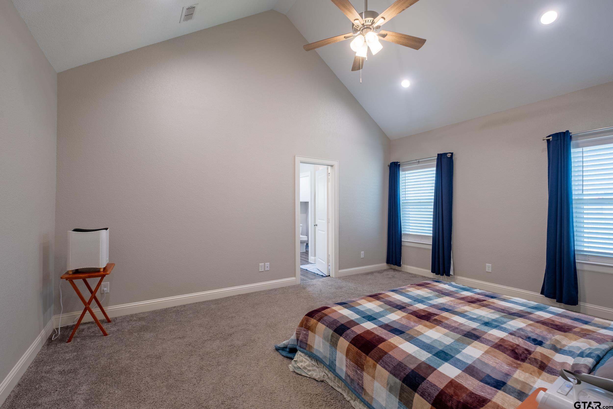 14348 County Road 452 Lindale, TX 75771 - Photo 14 of 45 a bedroom with a bed and a chandelier