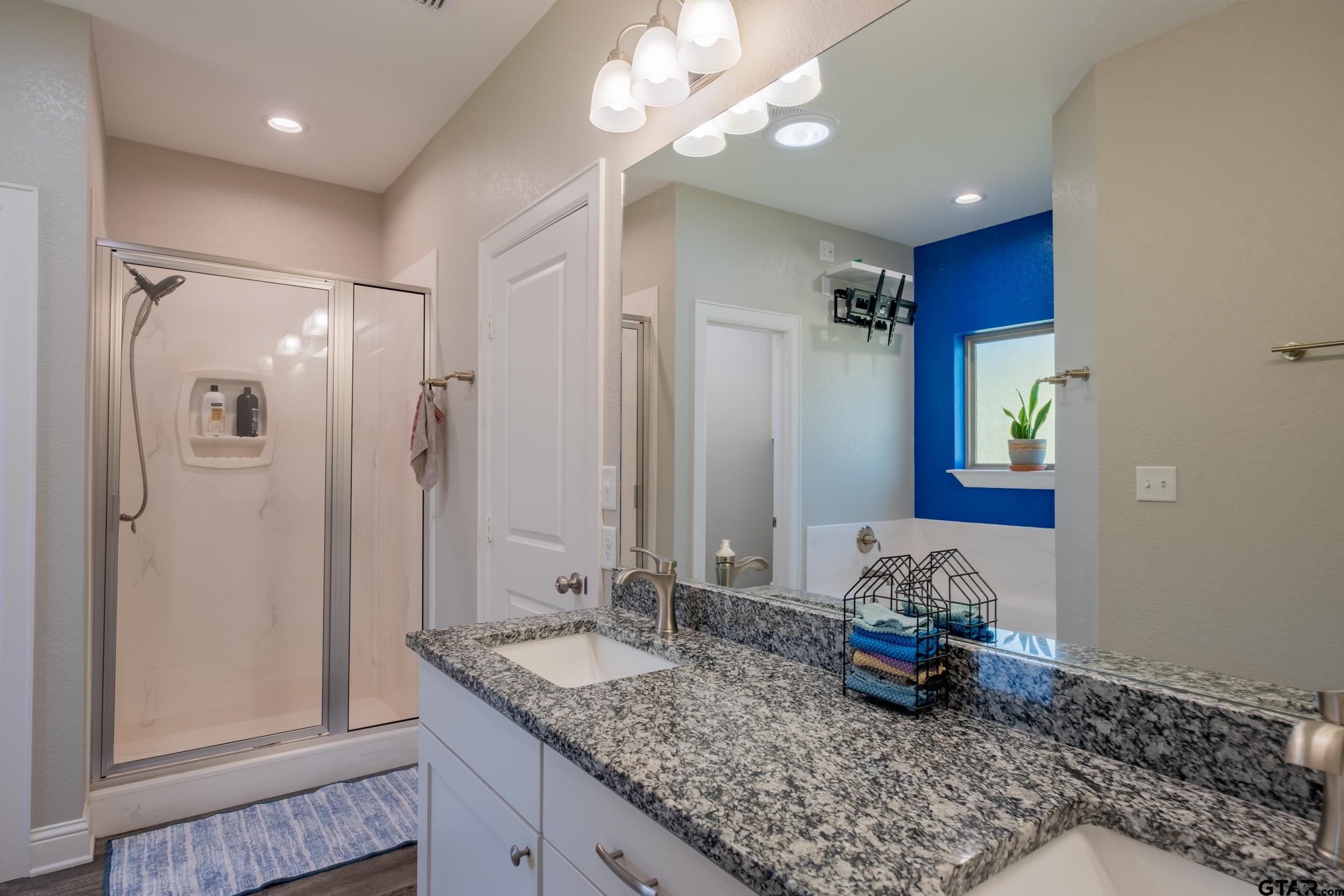14348 County Road 452 Lindale, TX 75771 - Photo 15 of 45 a bathroom with a granite countertop sink and a mirror