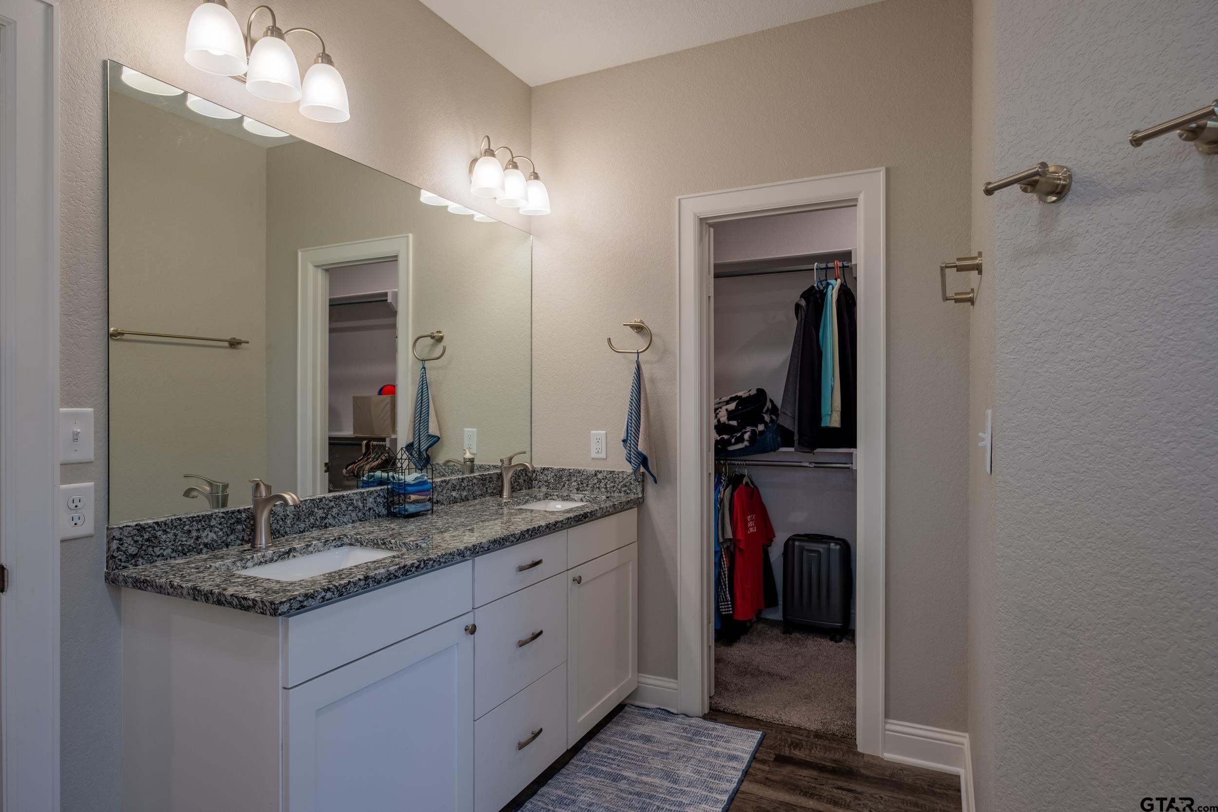 14348 County Road 452 Lindale, TX 75771 - Photo 16 of 45 a bathroom with a granite countertop sink and a mirror