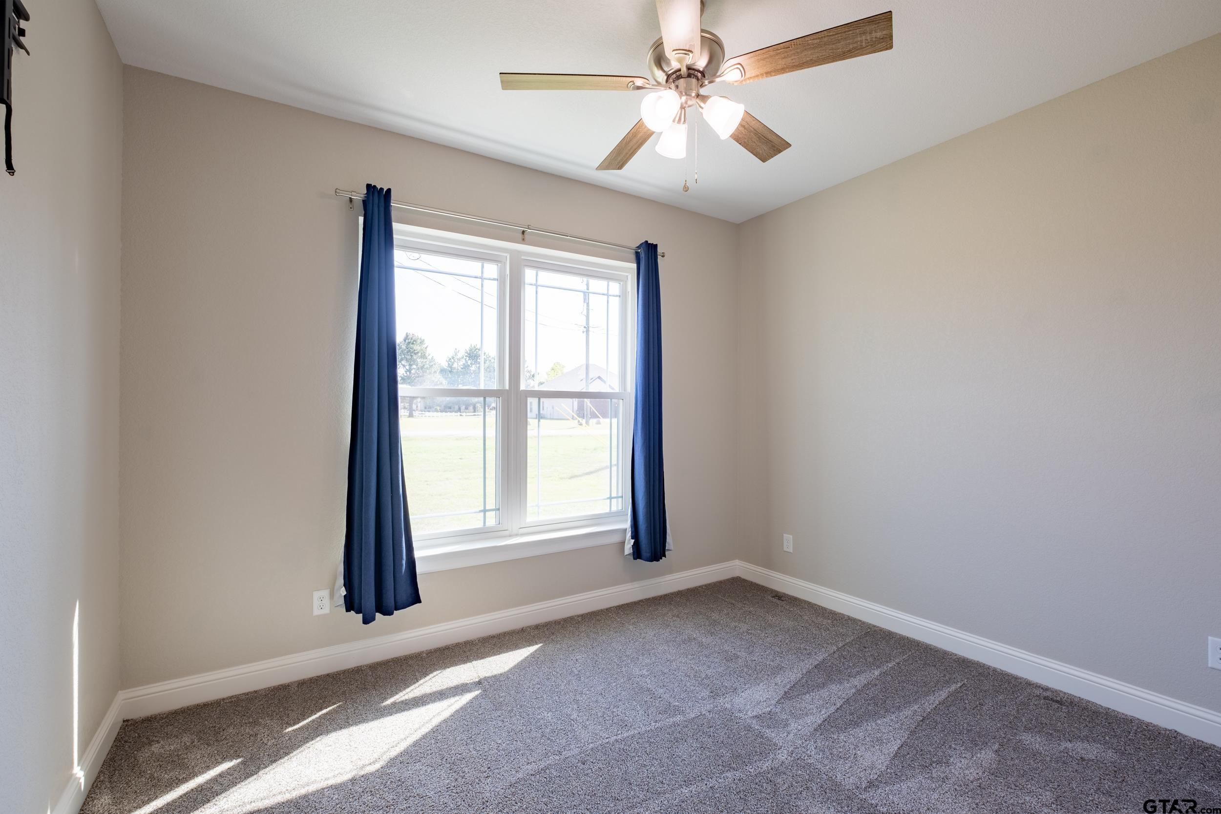 14348 County Road 452 Lindale, TX 75771 - Photo 24 of 45 an empty room with windows and fan