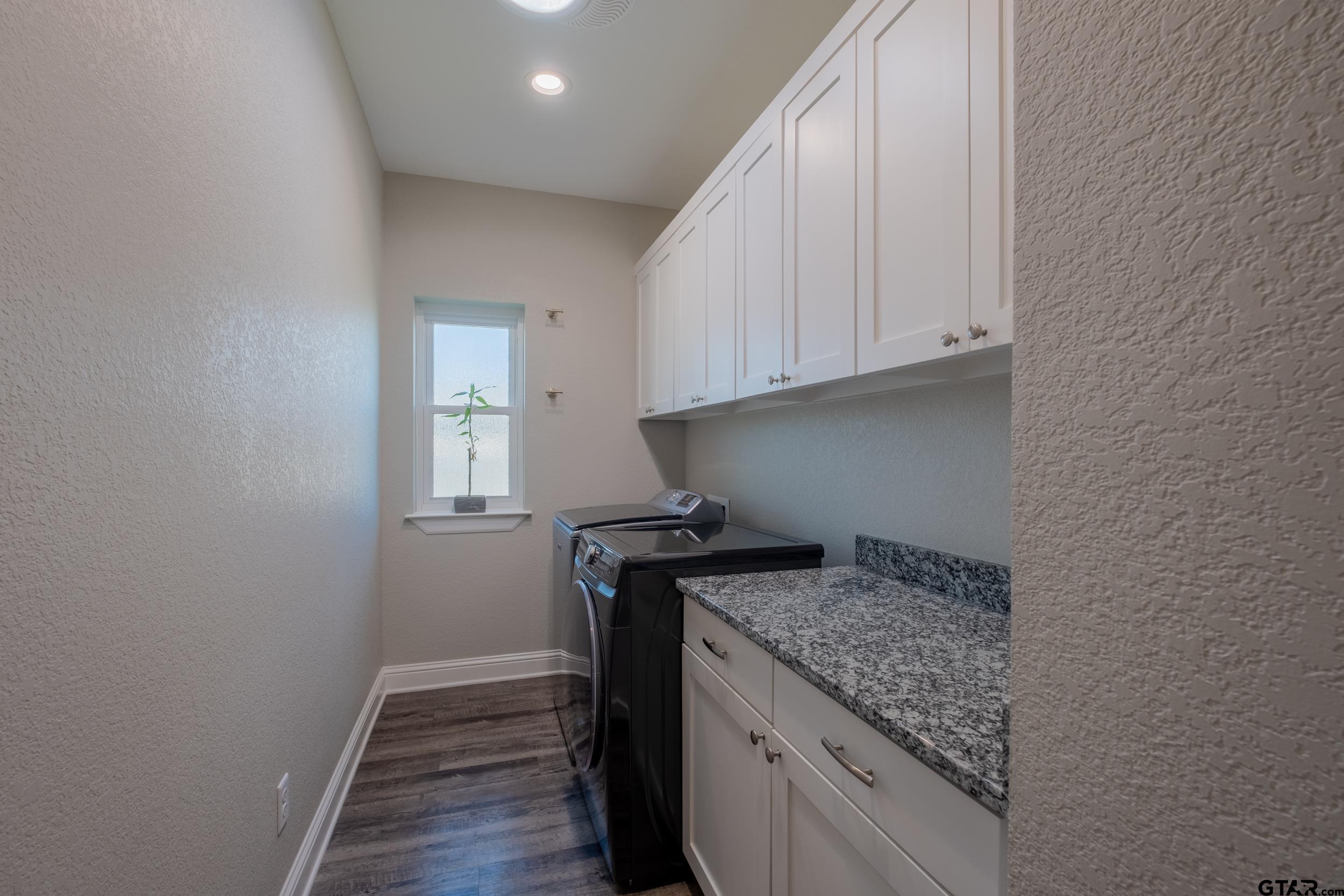 14348 County Road 452 Lindale, TX 75771 - Photo 27 of 45 a kitchen with granite countertop a stove and a refrigerator