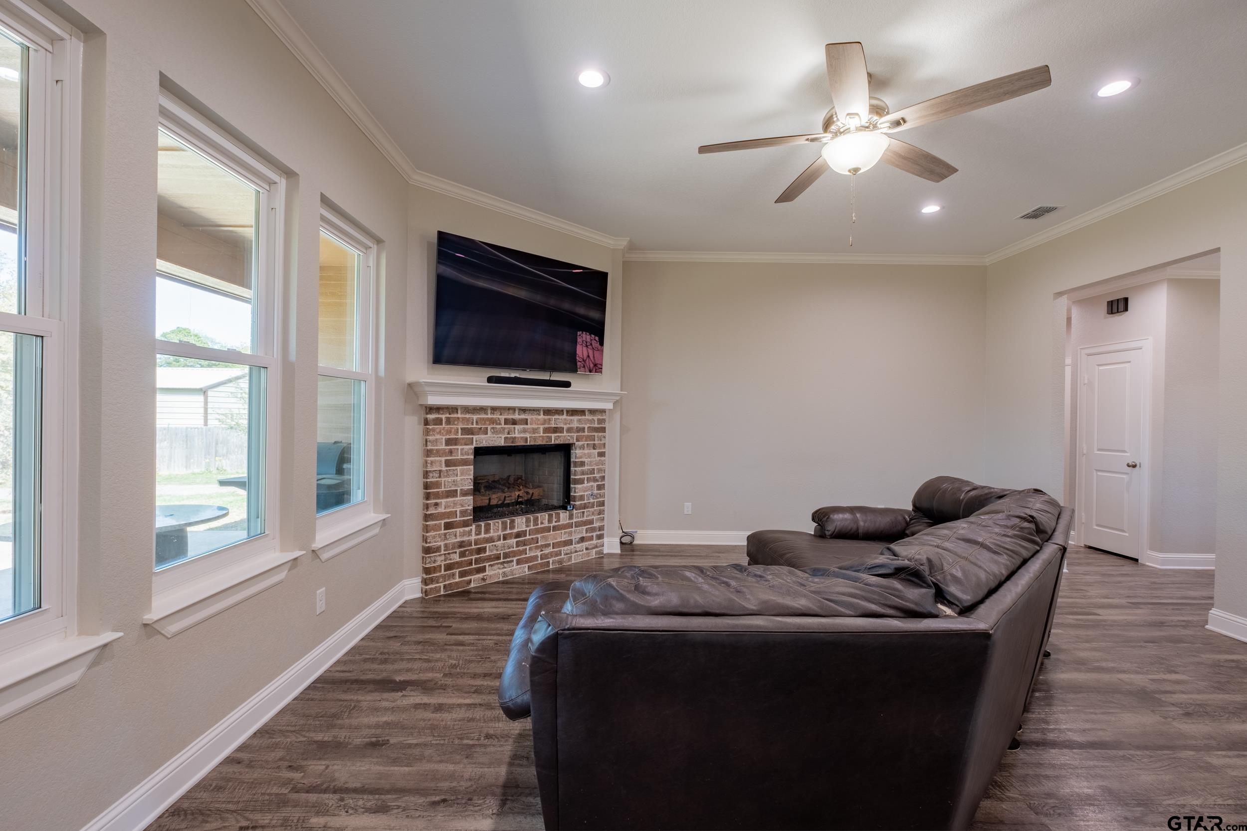 14348 County Road 452 Lindale, TX 75771 - Photo 5 of 45 a living room with furniture a flat screen tv and a fireplace