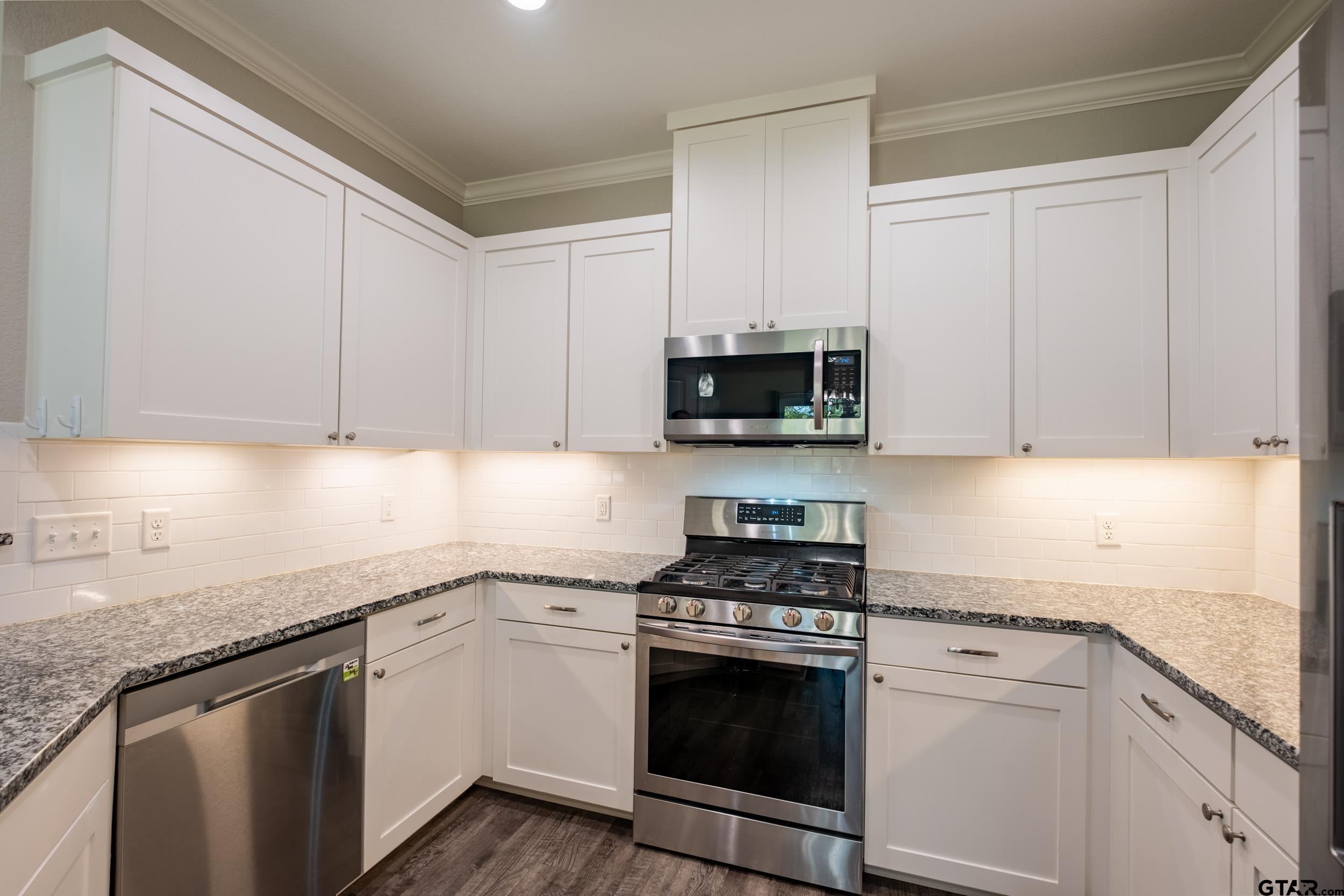 14348 County Road 452 Lindale, TX 75771 - Photo 9 of 45 a kitchen with granite countertop white cabinets and stainless steel appliances