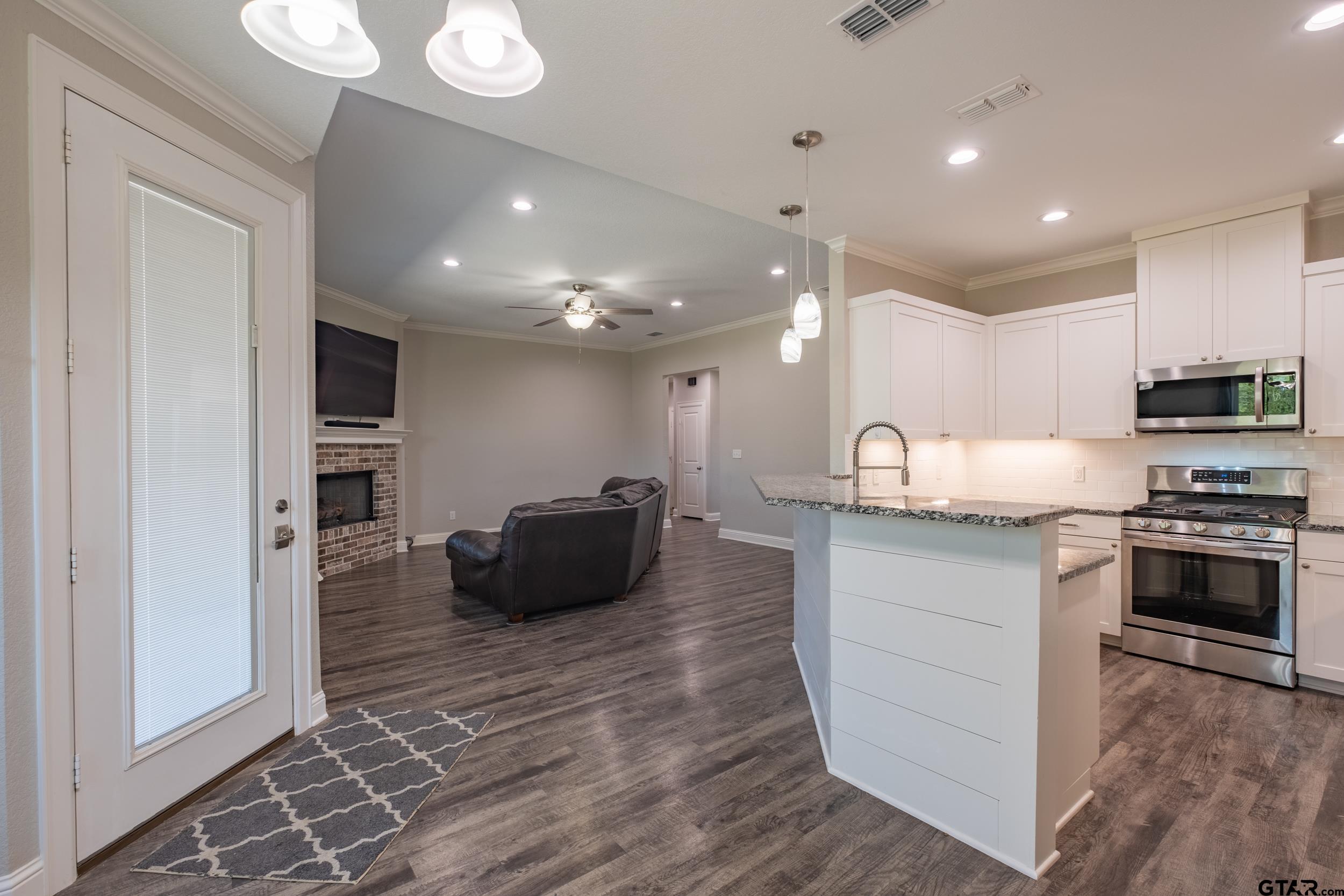 14348 County Road 452 Lindale, TX 75771 - Photo 10 of 45 a large kitchen with stainless steel appliances granite countertop a stove a sink and a refrigerator