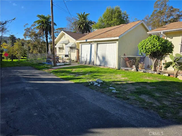 a view of a house with a yard and garage