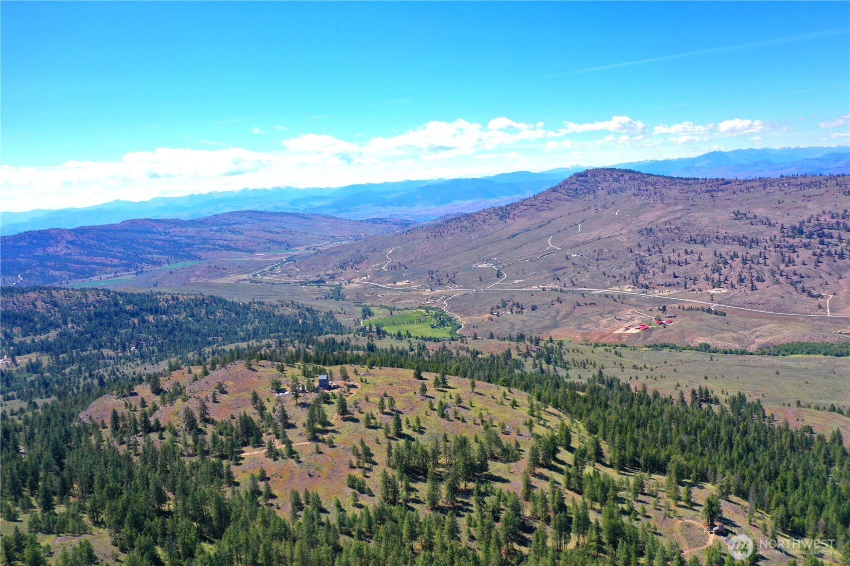 333 Patterson Creek Road Tonasket, WA 98855 - Photo 3 of 30 a view of a city with mountains in the background