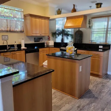 a kitchen with stainless steel appliances granite countertop a sink counter space and a window