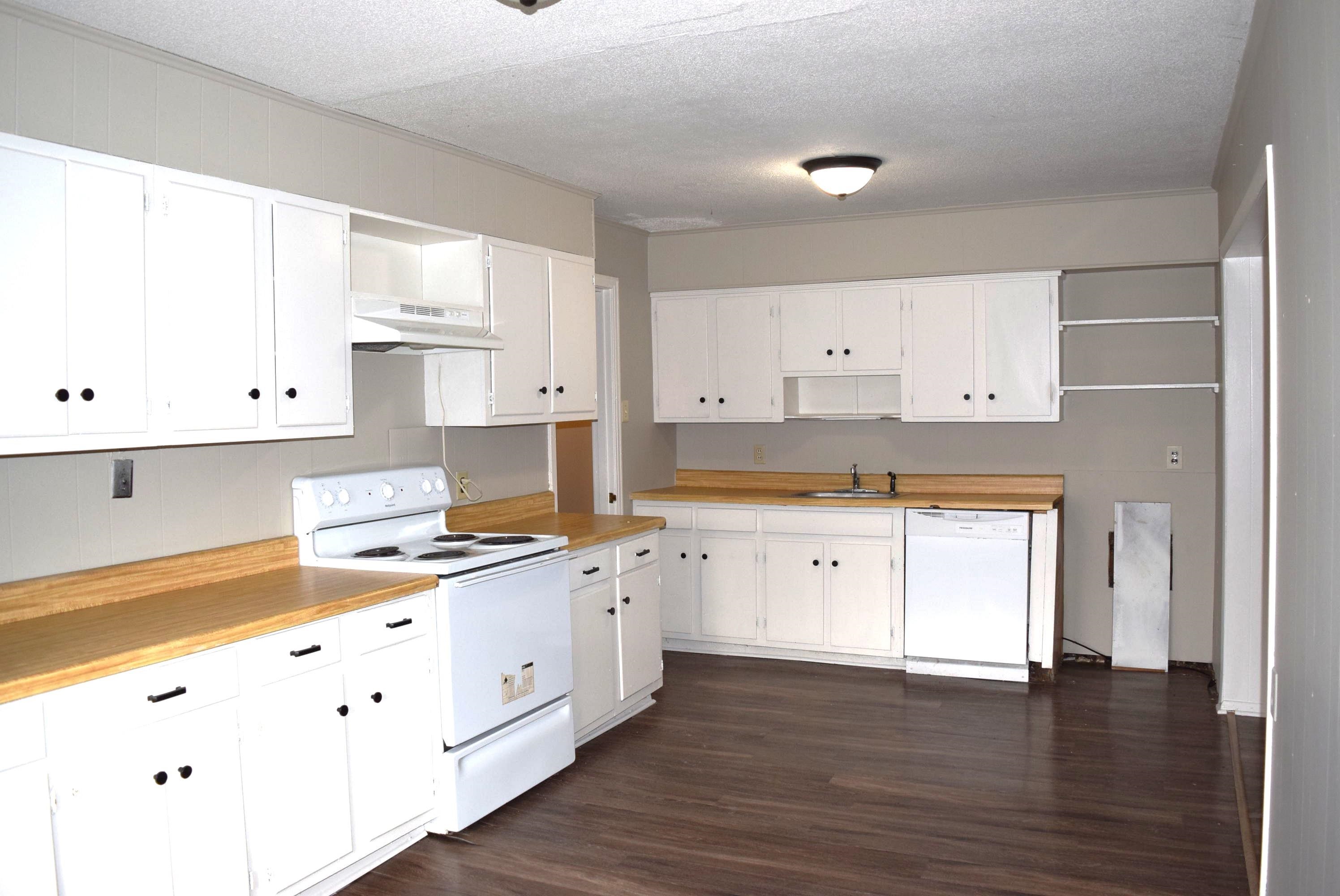 4895 Given Avenue Memphis, TN 38122 - Photo 6 of 19 a large white kitchen with stainless steel appliances granite countertop a stove a sink and white cabinets