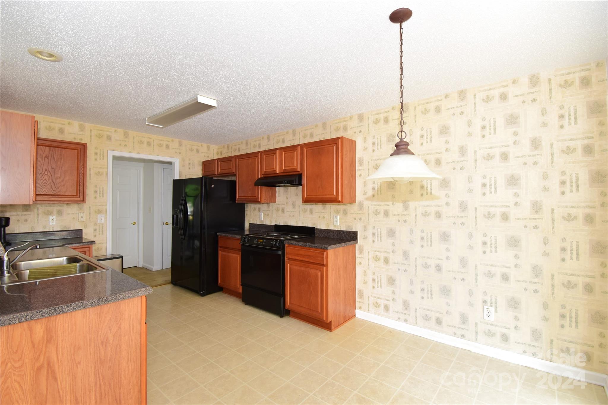 65 Cottage Ridge Road Fletcher, NC 28732 - Photo 12 of 40 a kitchen with stainless steel appliances kitchen island granite countertop a refrigerator a sink and dishwasher