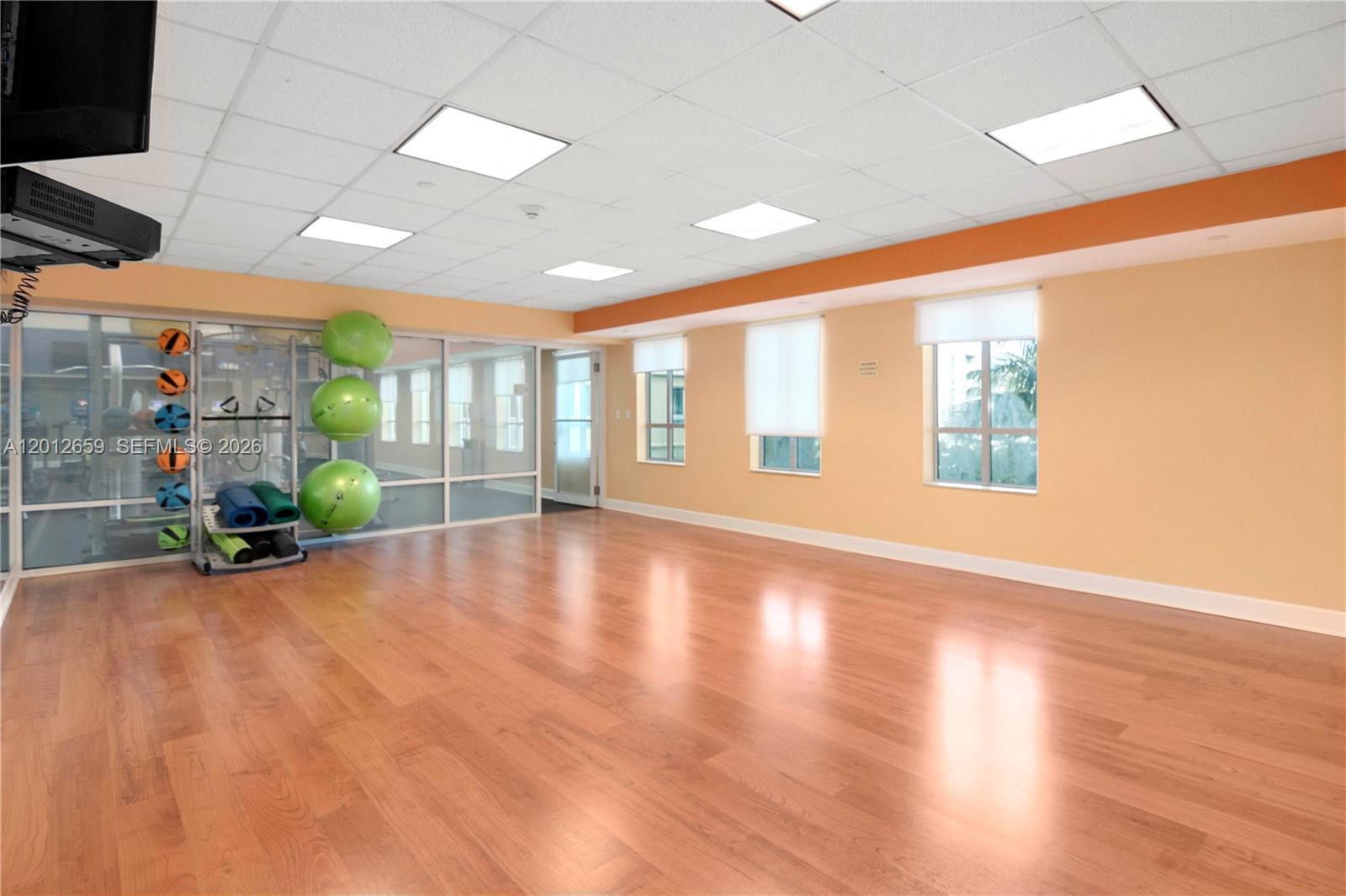 7355 Southwest 89th Street, Unit 501N Miami, FL 33156 - Photo 16 of 21 an empty room with wooden floor and windows