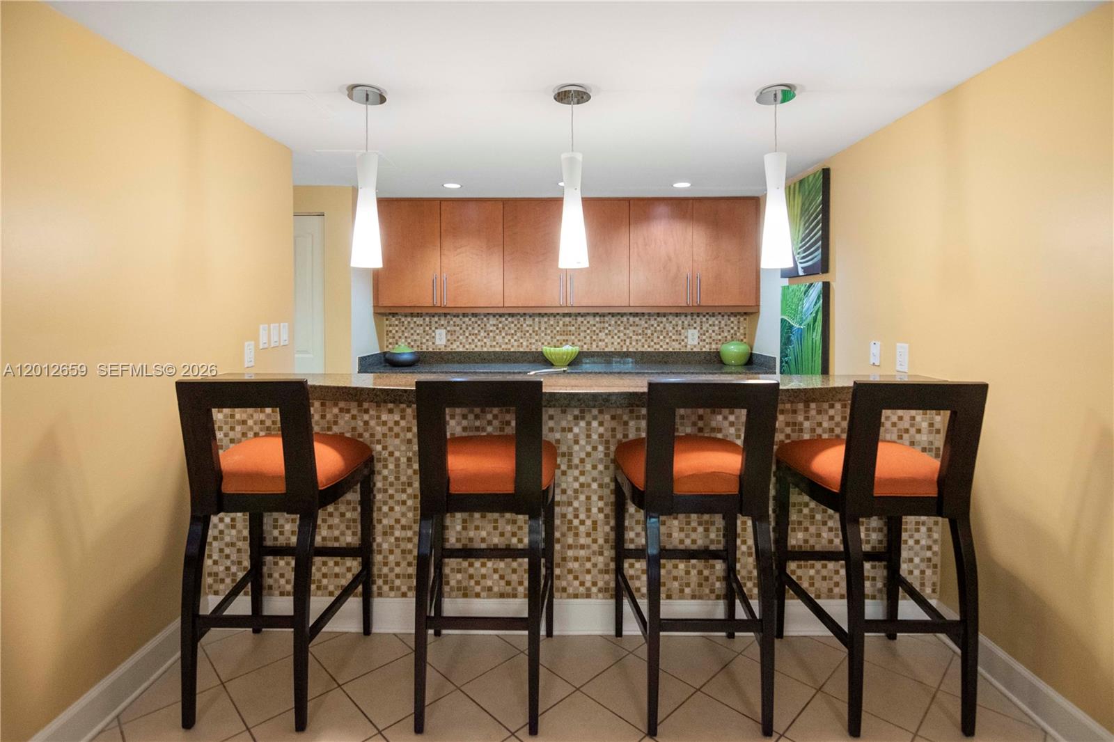 7355 Southwest 89th Street, Unit 501N Miami, FL 33156 - Photo 19 of 21 a kitchen with a dining table chairs cabinets and stainless steel appliances