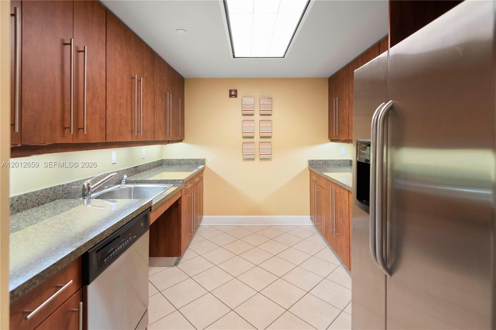 7355 Southwest 89th Street, Unit 501N Miami, FL 33156 - Photo 20 of 21 a kitchen with stainless steel appliances granite countertop a sink and a refrigerator