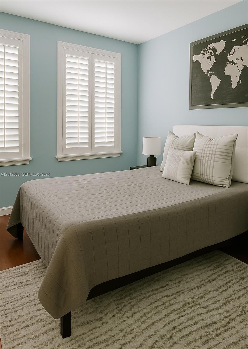 7355 Southwest 89th Street, Unit 501N Miami, FL 33156 - Photo 3 of 21 a bed sitting in a bedroom next to a window