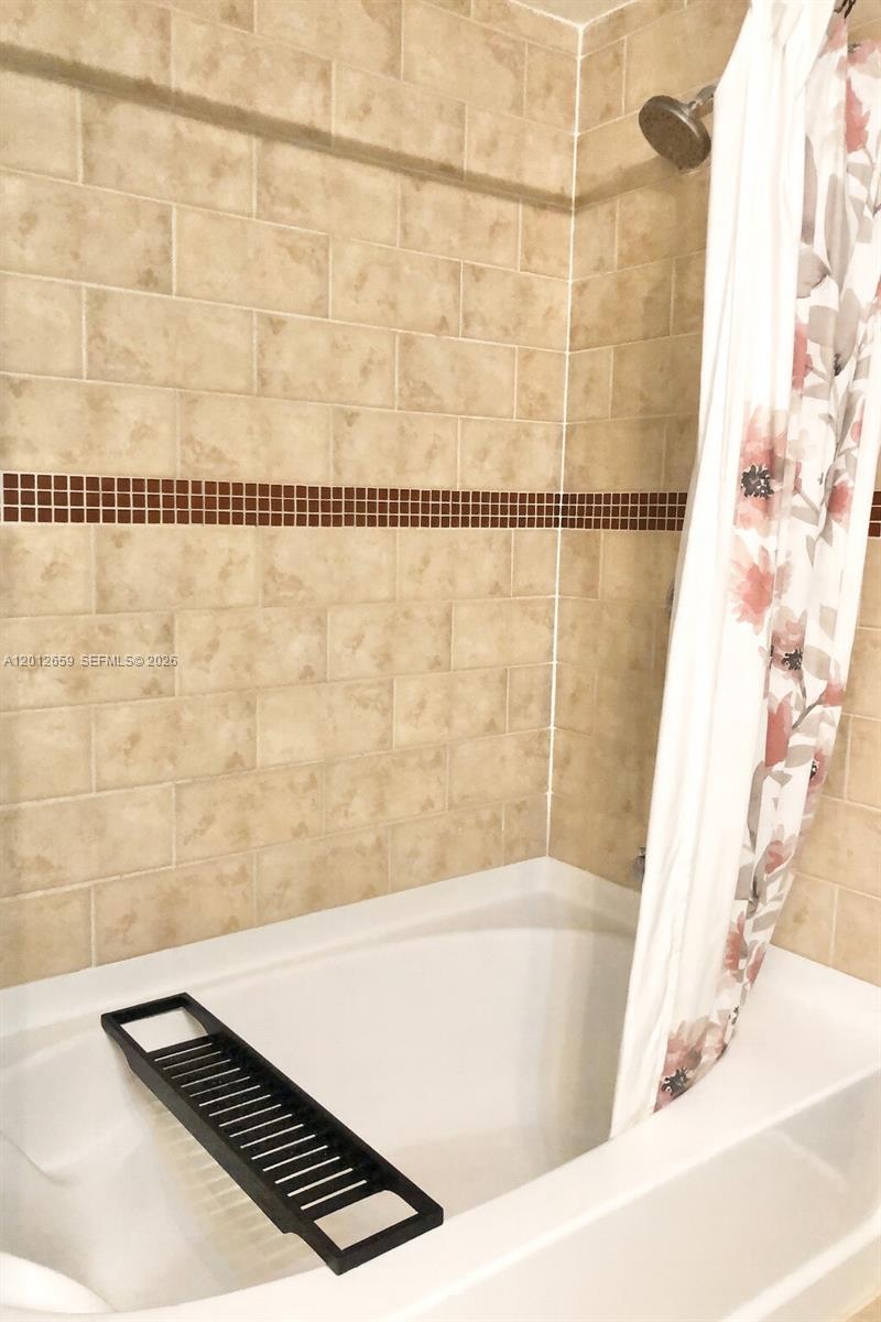 7355 Southwest 89th Street, Unit 501N Miami, FL 33156 - Photo 6 of 21 a bathroom with a bathtub