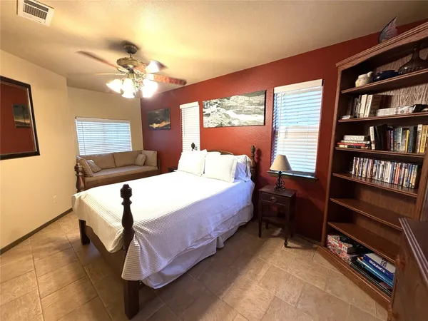 a bedroom with a bed closet and a chandelier
