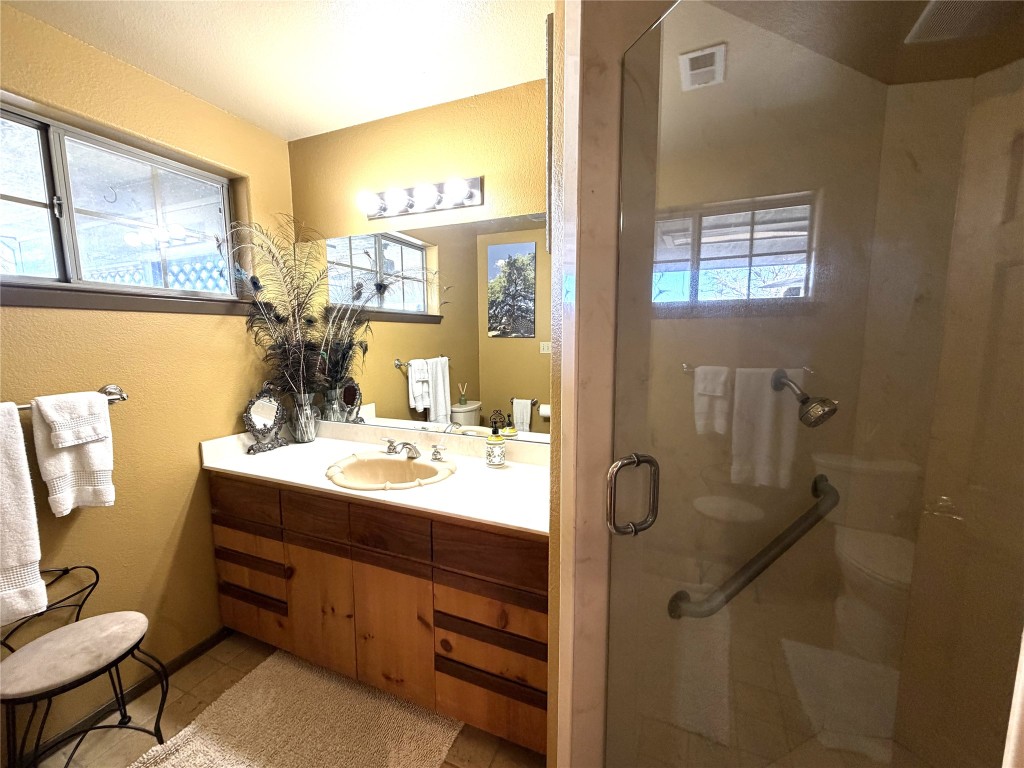 2035 Borchert Loop Lockhart, TX 78644 - Photo 13 of 25 a bathroom with a sink mirror and a shower