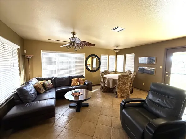 a living room with furniture a rug and a window