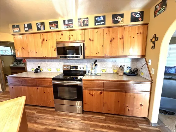 a kitchen with stainless steel appliances granite countertop a stove and a sink