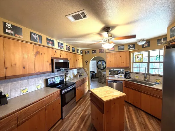 a kitchen with a stove a sink and a refrigerator