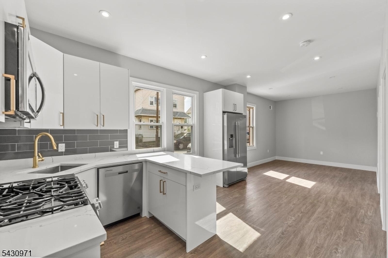 59 Locust Avenue, Unit 1R Wallington, NJ 07057 - Photo 1 of 10 a kitchen with stainless steel appliances granite countertop a sink stove and refrigerator