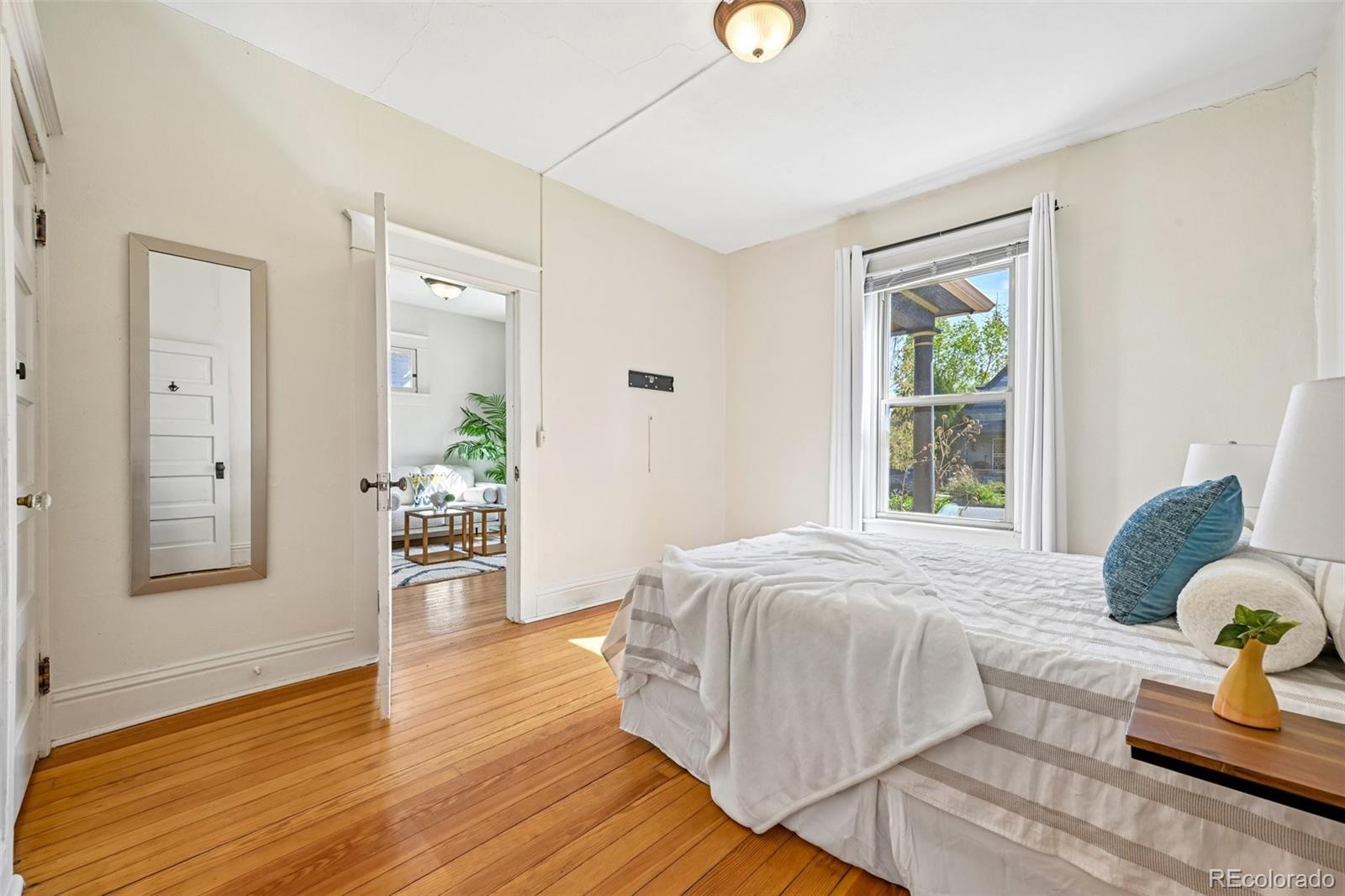 3275 Perry Street Denver, CO 80212 - Photo 14 of 38 a spacious bedroom with a bed and wooden floor