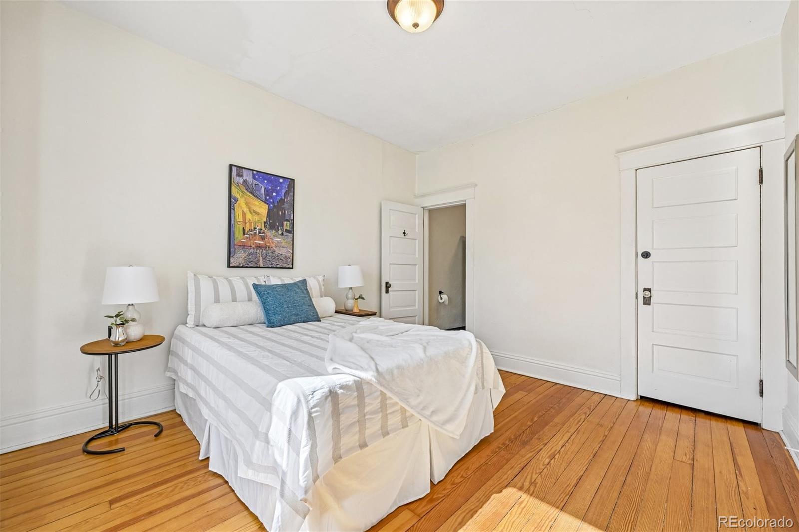 3275 Perry Street Denver, CO 80212 - Photo 15 of 38 a bed room with a bed and a lamp