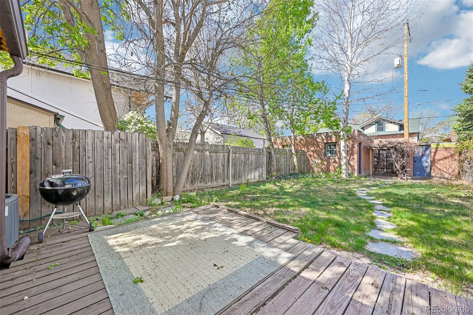 3275 Perry Street Denver, CO 80212 - Photo 21 of 38 a backyard of a house with table and chairs