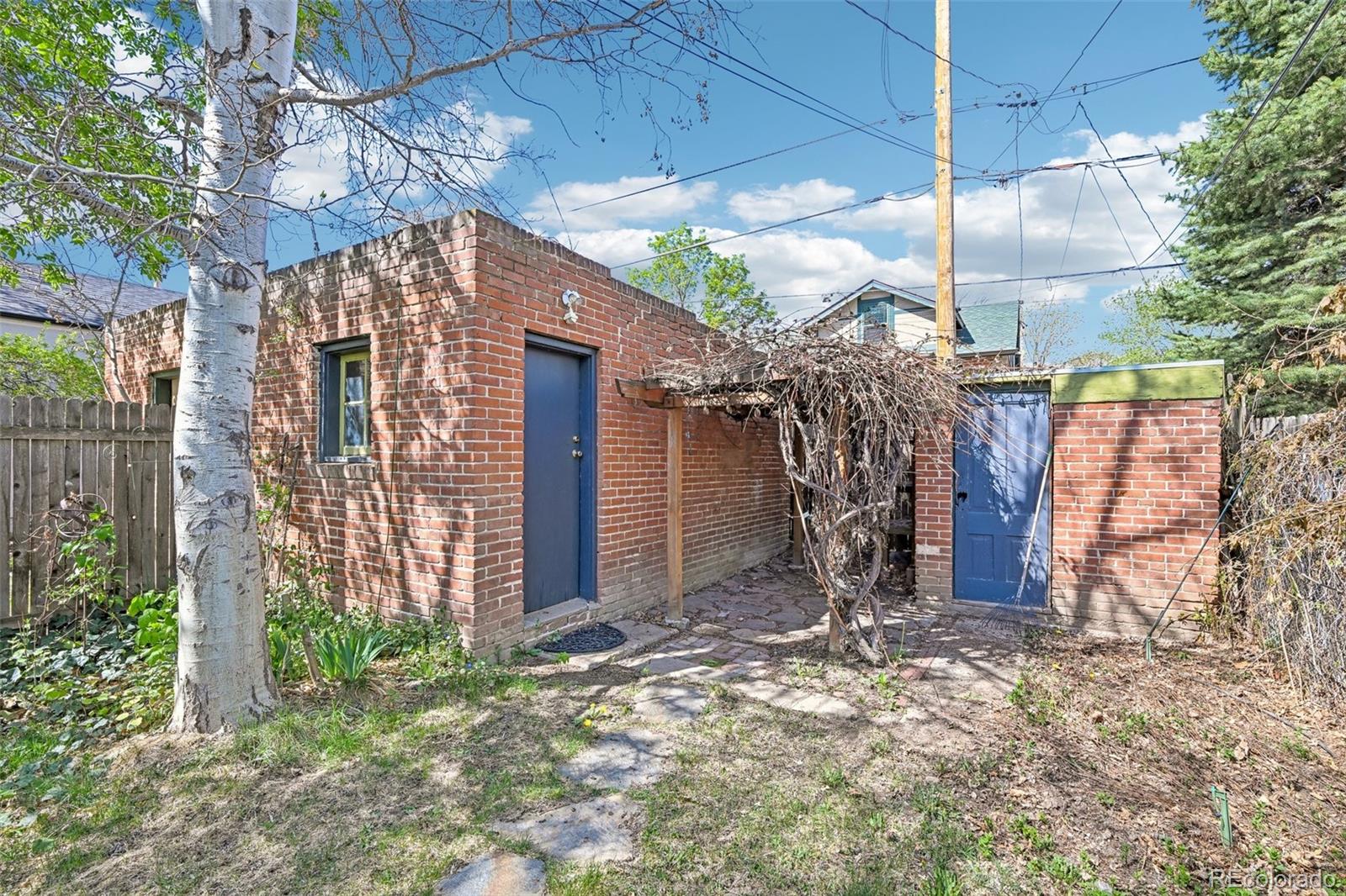 3275 Perry Street Denver, CO 80212 - Photo 24 of 38 a view of a wooden house with a large tree and wooden fence