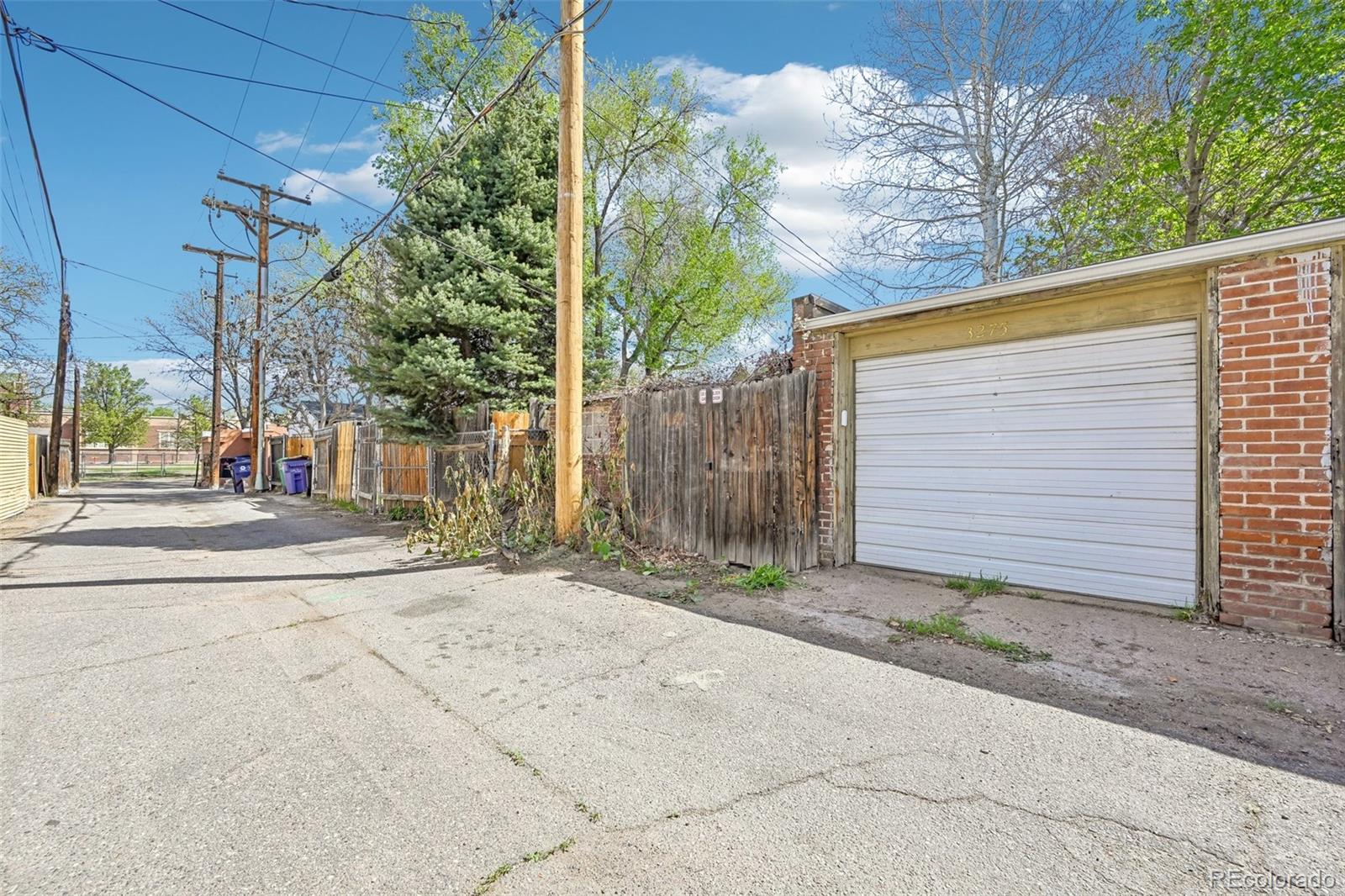 3275 Perry Street Denver, CO 80212 - Photo 28 of 38 a view of a entrance gate of the house and tree