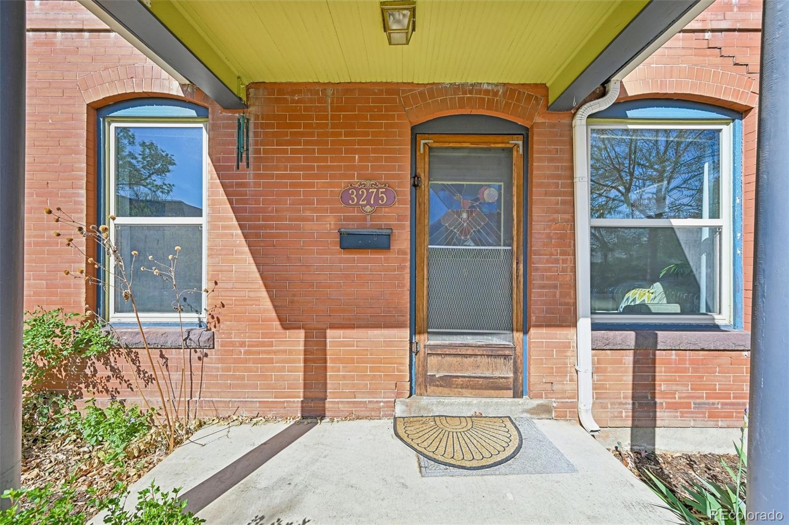 3275 Perry Street Denver, CO 80212 - Photo 3 of 38 a front view of a house with a yard
