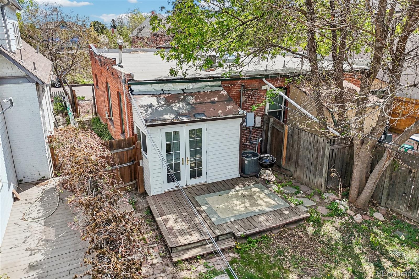 3275 Perry Street Denver, CO 80212 - Photo 32 of 38 a view of a house with a small yard and wooden fence