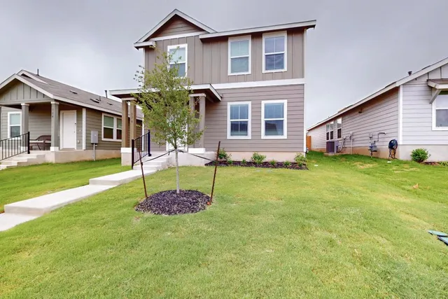 a front view of a house with a yard
