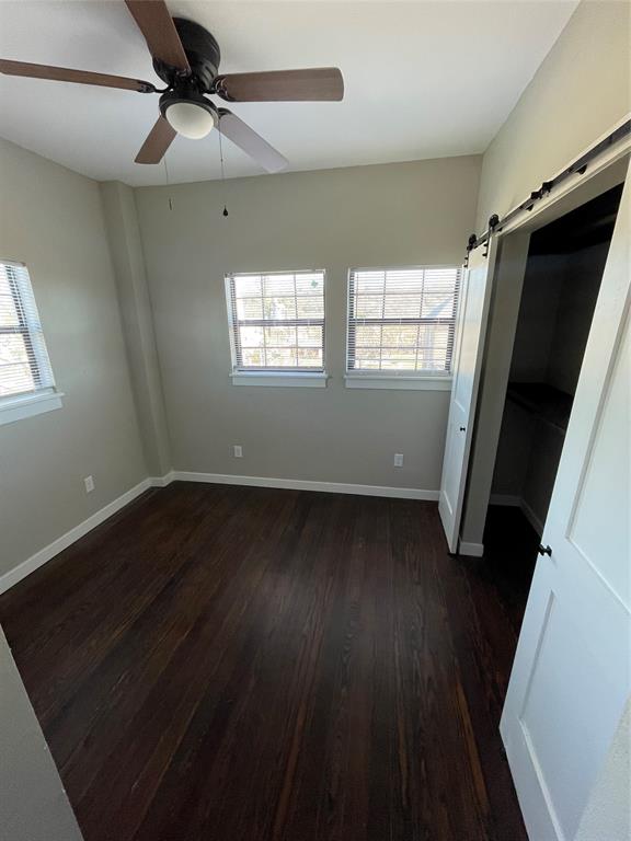 707 Northwest 4th Avenue, Unit 303 Mineral Wells, TX 76067 - Photo 4 of 9 a view of a room with wooden floor and windows