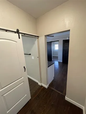 a view of a hallway view with wooden floor and staircase