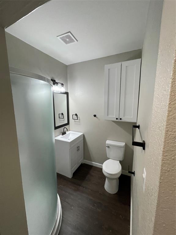 707 Northwest 4th Avenue, Unit 303 Mineral Wells, TX 76067 - Photo 6 of 9 a bathroom with a toilet sink and mirror