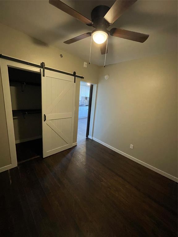 707 Northwest 4th Avenue, Unit 303 Mineral Wells, TX 76067 - Photo 7 of 9 a view of empty room with wooden floor