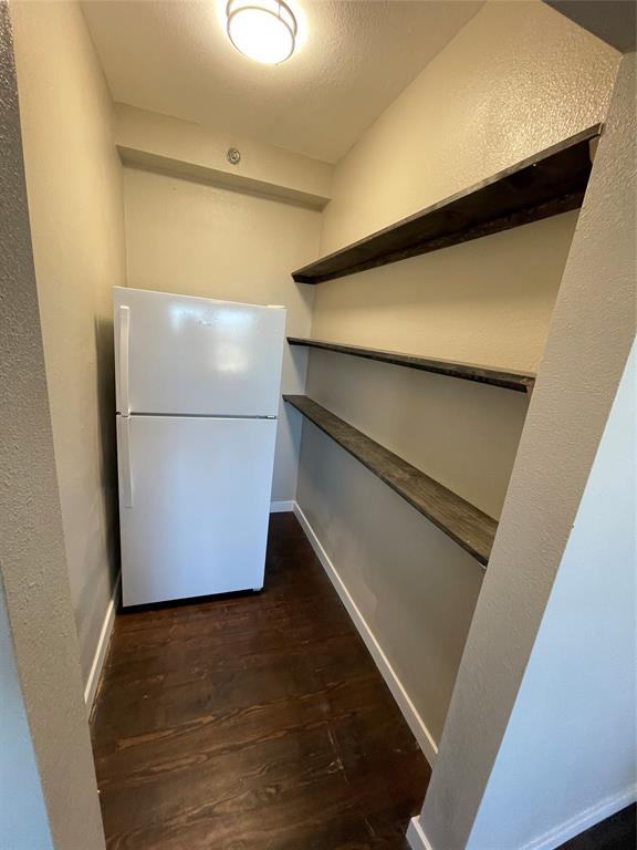 707 Northwest 4th Avenue, Unit 303 Mineral Wells, TX 76067 - Photo 8 of 9 a refrigerator freezer sitting inside of a kitchen