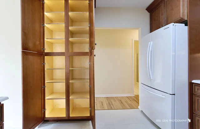 a kitchen with stainless steel appliances kitchen island a table and chairs in it
