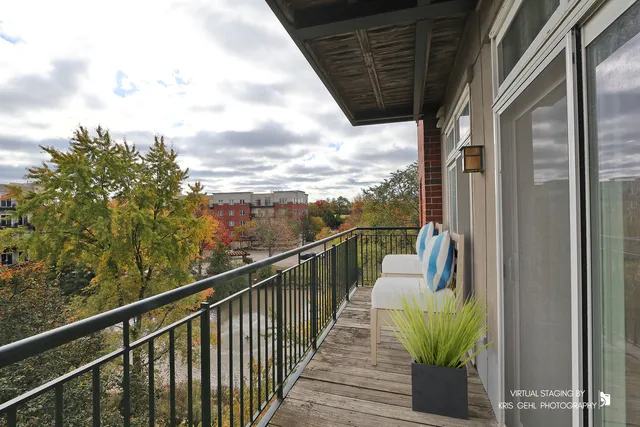 a view of balcony with wooden floor and fence